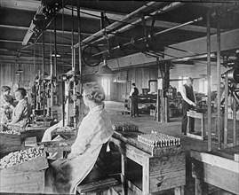 Men and women working at the Express Spark Plug Company ca.  between 1910 and 1926