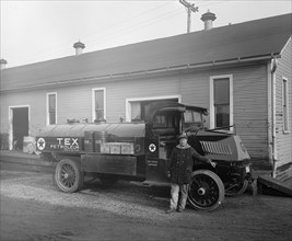 Man standing outside a Texaco Company Ace oil truck ca.  between 1910 and 1926