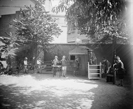Children playing outside at Mrs. Tomlin's School ca.  between 1910 and 1925