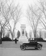 Ford Motor Company, parked in front of a monument, man standing outside ca.  between 1910 and 1926