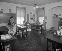 School students doing their lessons at Mrs. Tomlin's School ca.  between 1910 and 1925