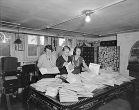 Workers going through envelopes for the Women's Party, Equal Rights essay contest ca. early 20th century