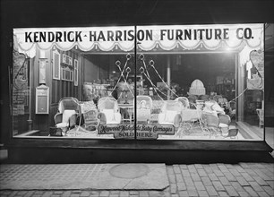 Kendrick Harrison Furniture Company window at night ca.  between 1910 and 1920