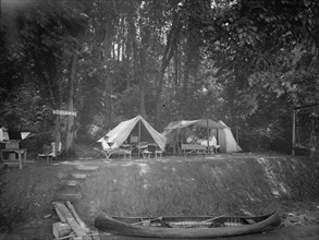 Summer camps: Canoe and campers at Tak it Ezy camp ca.  between 1910 and 1935