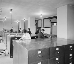 Workers looking through files at the Bureau of Identification ca.  between 1910 and 1926