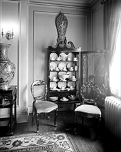 Home interior, china cabinet and chairs ca.  between 1910 and 1925