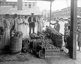 Customers at a food market, Washington D.C., World War I period. ca.  between 1910 and 1920