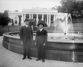 Thomas H. Fearey & Charles DeMitt Marcey standing next to a water fountain ca.  between 1910 and 1926
