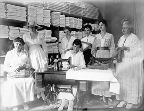 Women performing textile work in early 20th century ca.  between 1910 and 1935