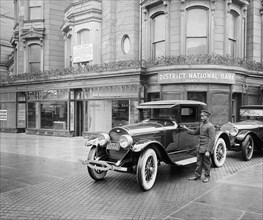 Luxury cars parked in front of the District National Bank, Dupont Branch, [Washington, D.C.]. ca.  between 1910 and 1920