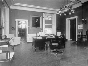 William Gibbs McAdoo sitting at his desk ca.  between 1910 and 1935