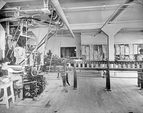 Carton Machine at the C&H Sugar factory. This machine folds, glues, fills, weighs and seals 30 2 lb. or 5 lb. cartons per minute with one operative ca.  between 1910 and 1920
