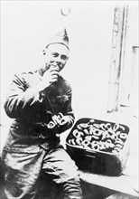U.S. soldier eating doughnuts ca.  1910