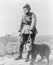 Soldier and his dog wearing gas masks ca.  1914