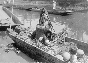 Women and a child on a boat in the MexiCompany Canal, Mexico City ca.  between 1909 and 1920