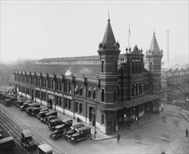 Trucks parked outside Grand Central Palace, which contains bowling alleys and billard parlor at Center Market, Washington, D.C. ca.  1910
