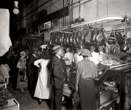 Customers at D.D. Collins meat stands (Stands 94 and 95) at the O Street Market located in the Shaw neighborhood of Washington, D.C. ca.  1915