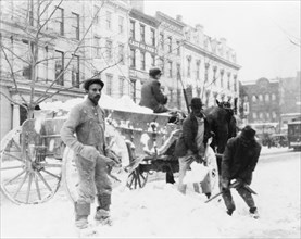 Men loading snow onto a wagon, after snow storm, in Washington, D.C. ca. [between 1909 and 1920]