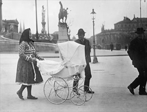 Austria. A Bohemian woman pushing a baby carriage  ca. between 1909 and 1920