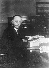 Secretary William Cox Redfield sitting at his desk ca. between 1909 and 1919