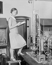 Woman scientist with experiment ca. between 1909 and 1923