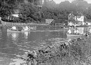 Men in boats and canoes on the C&O Canal ca. between 1909 and 1919
