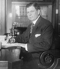 Senator Park Trammell of Florida sitting at his desk  ca. between 1909 and 1920