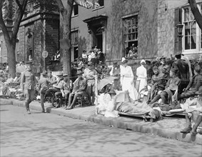 Men, women and children watching the Pershing parade ca. between 1909 and 1923