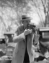 Unidentified photographer with camera ca. between 1909 and 1923