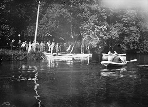 Men rowing boats on the C&O Canal ca. between 1909 and 1919