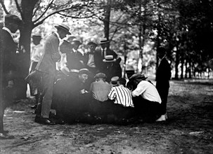 Men participating in a crap game, shooting craps ca. between 1909 and 1920
