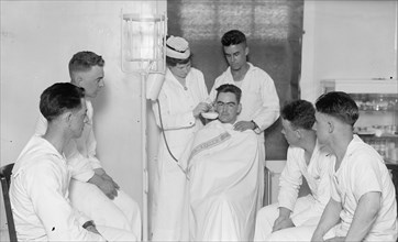 Nurse and patients at a Naval hospital ca. between 1909 and 1923