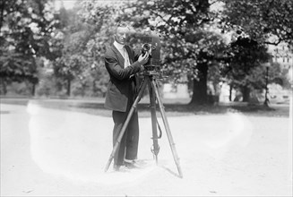 Charlie Simons with camera ca. between 1909 and 1920