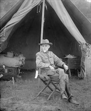 Lt. Pearsell sitting in front of a tent ca. between 1909 and 1920