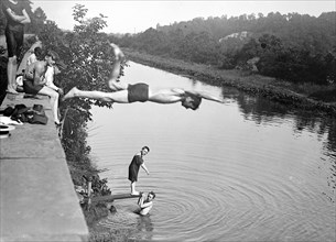 Boy diving into the C&O Canal, others playing in the water ca. between 1909 and 1919