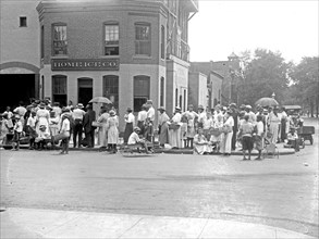 People waiting in line for ice outside the Home Ice Company ca. between 1909 and 1920