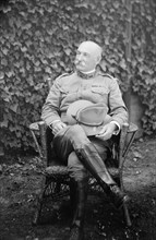 Colonel Joseph Garrad sitting in a chair ca. between 1909 and 1920