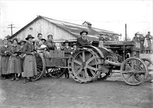 National Women's Defense League Camp, man driving a CASE tractor ca. between 1909 and 1940