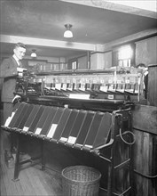 Man working a sorting machine at the U.S. Census Bureau ca. between 1909 and 1940