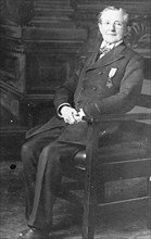 Dr. Neary Wallace sitting in a chair ca. between 1909 and 1919