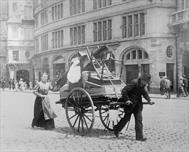 Man and woman moving their household belongings through the streets on a cart in Berlin Germany  ca. between 1909 and 1920