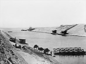 Suez Canal and Lake Timsah, men with camels in the foreground ca. between 1909 and 1919