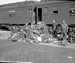 1st Division boys, World War I taking a rest outside of a train car ca. between 1909 and 1932