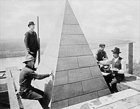 Workmen completing work on the top of the Washington Monument ca. between 1909 and 1940