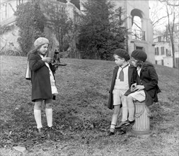 Children with camera ca. between 1909 and 1923