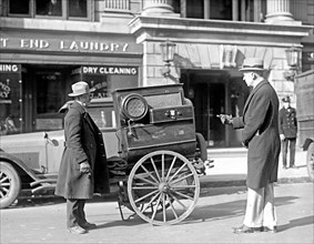 Street scene: men and cart near laundry ca. between 1909 and 1932