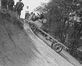 Four wheel drive climbing up a dirt hill ca. between 1909 and 1932