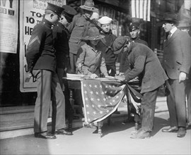 Miss Dora Rodrigues recruiting, members of various branches of armed services around her [World War I] ca. between 1909 and 1940