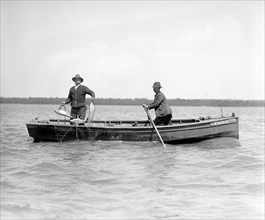 Two men in a boat shad fishing on the Potomac ca. between 1909 and 1932