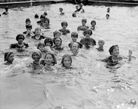 Kids having fun at a municipal bathing beach or city swimming pool ca. between 1909 and 1919